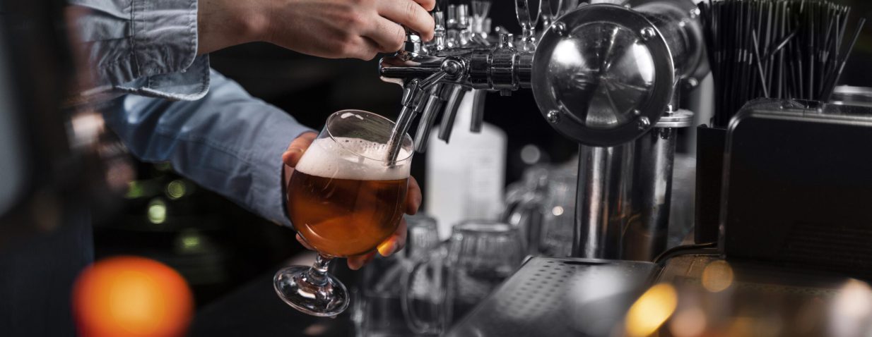 close-up-hand-pouring-beer-glass